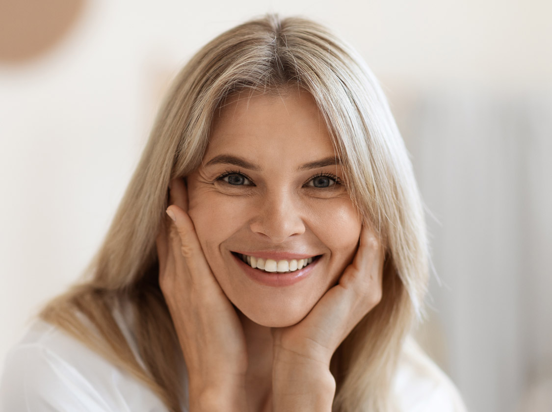 Beautiful middle aged woman smiling at camera, closeup portrait