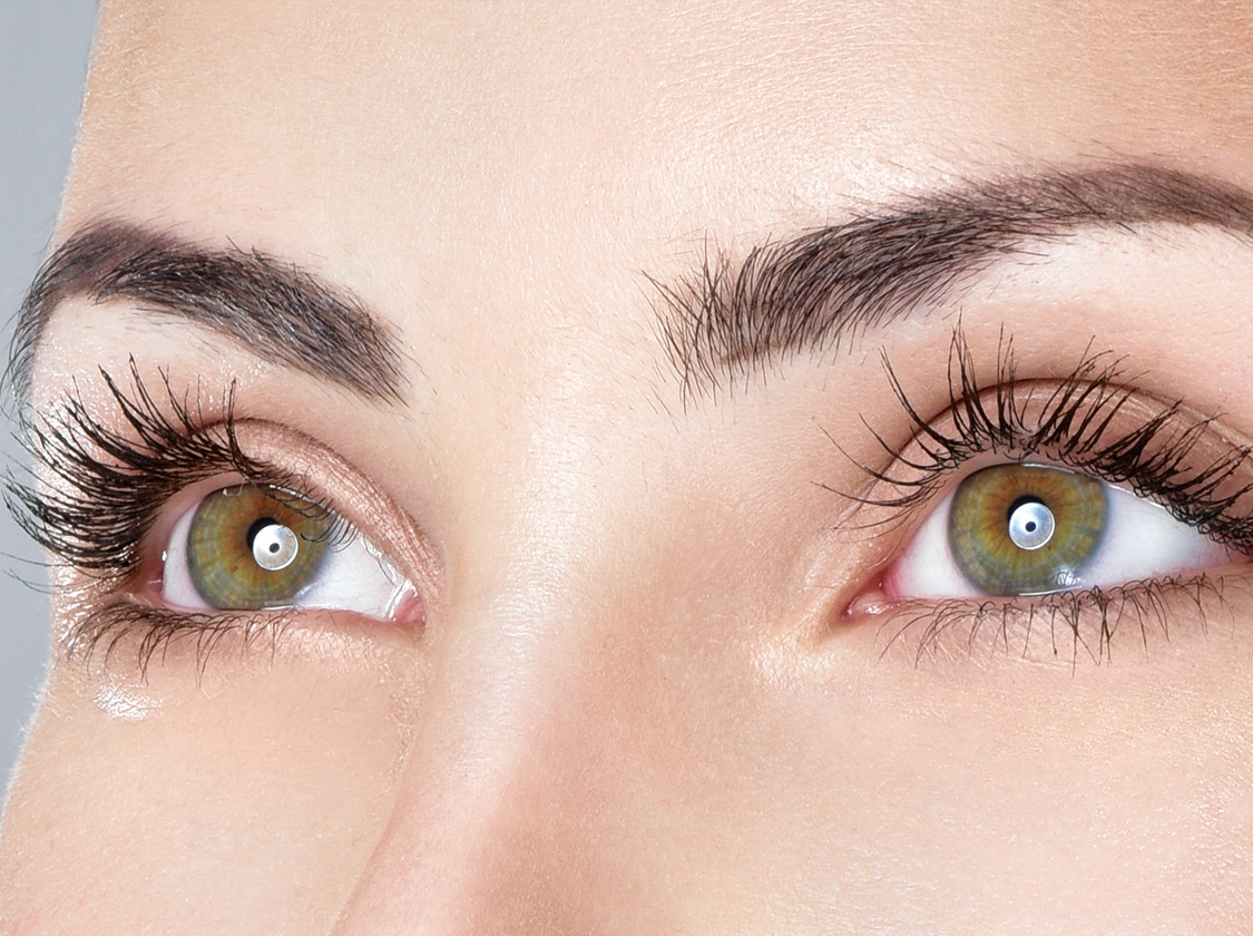 Close-up of a woman's eyes and arched eyebrows with long lashes